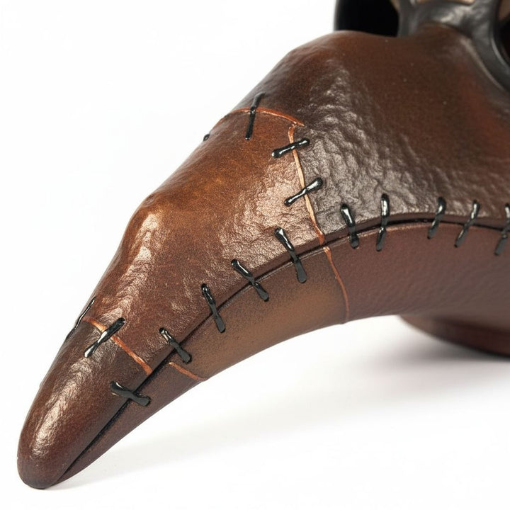 A close-up image of a brown leather object with a pointed end and a stitched pattern.